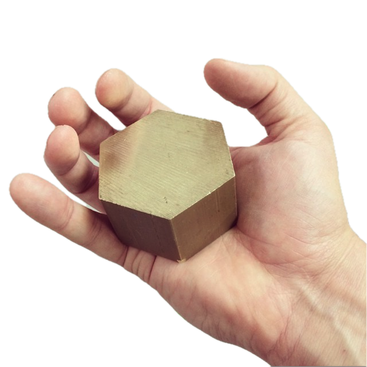 Cast brass hexagonal form held in a hand